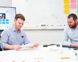 Medical device designers discussing a document