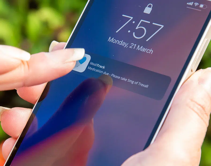 Image showing mobile phone application use in medical device development services