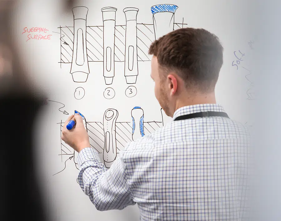 Medical Device Design Engineer Brainstorming drug delivery device concepts