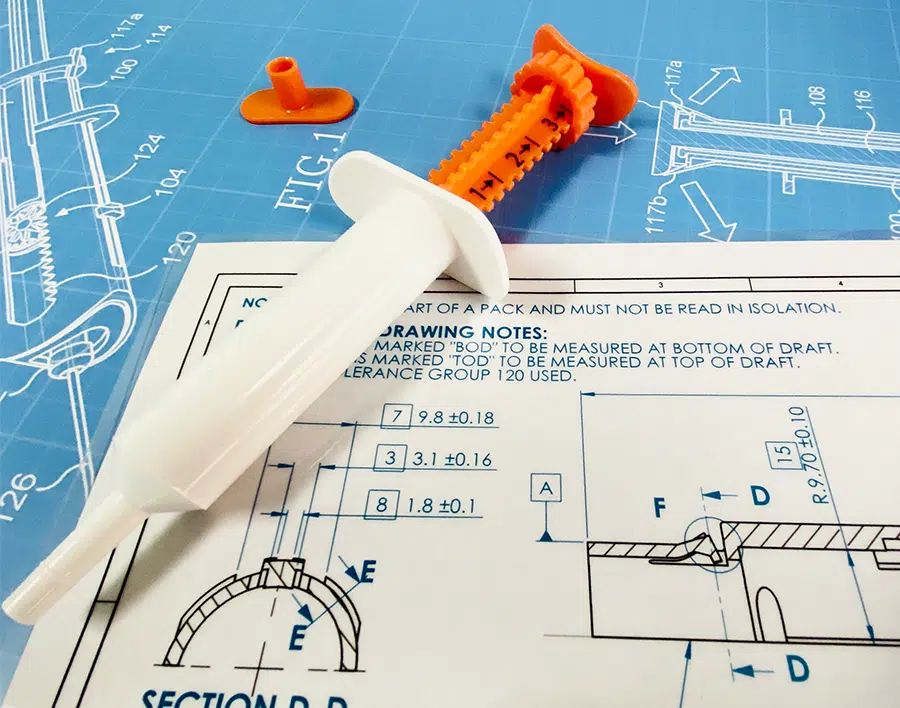 Image showing medical device prototype with engineering drawings - medical device development services