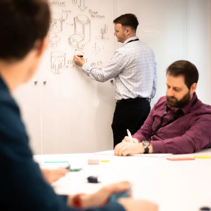 Medical device designers sketching an inhalation device